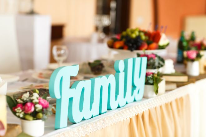 blue color word family at the wedding table near  flowers